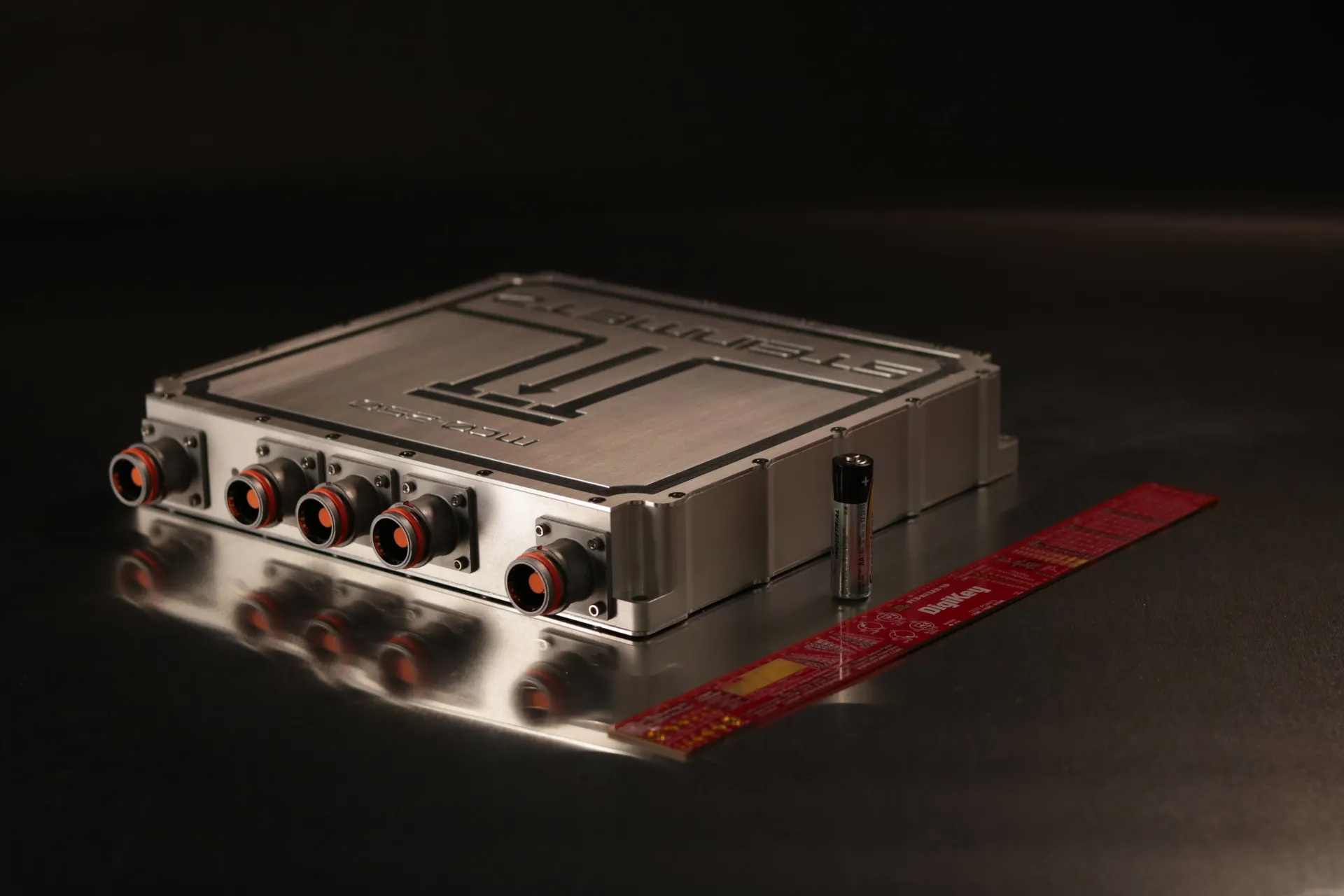 Steinmetz MC0-250 motor controller manufacturing facility background showing American-made electric vehicle components